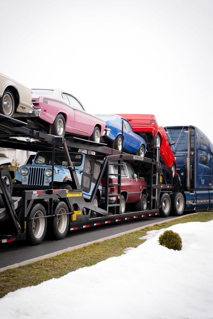 Vintage muscle cars loaded on an Allstar Hauling trailer
