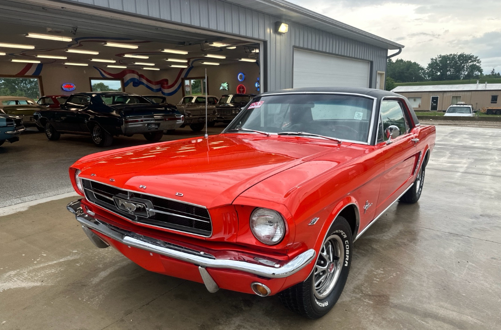 Red 1965 Ford Mustang coupe transported by Allstar Hauling