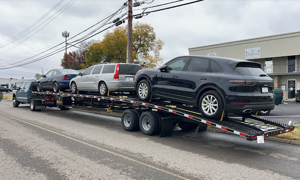Porsche Cayenne on an Allstar Hauling three-car wedge trailer