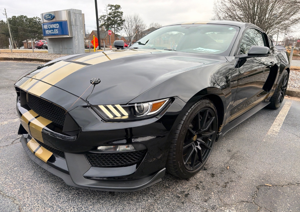 Black Ford Shelby GT350 with gold stripes hauled by Allstar Hauling