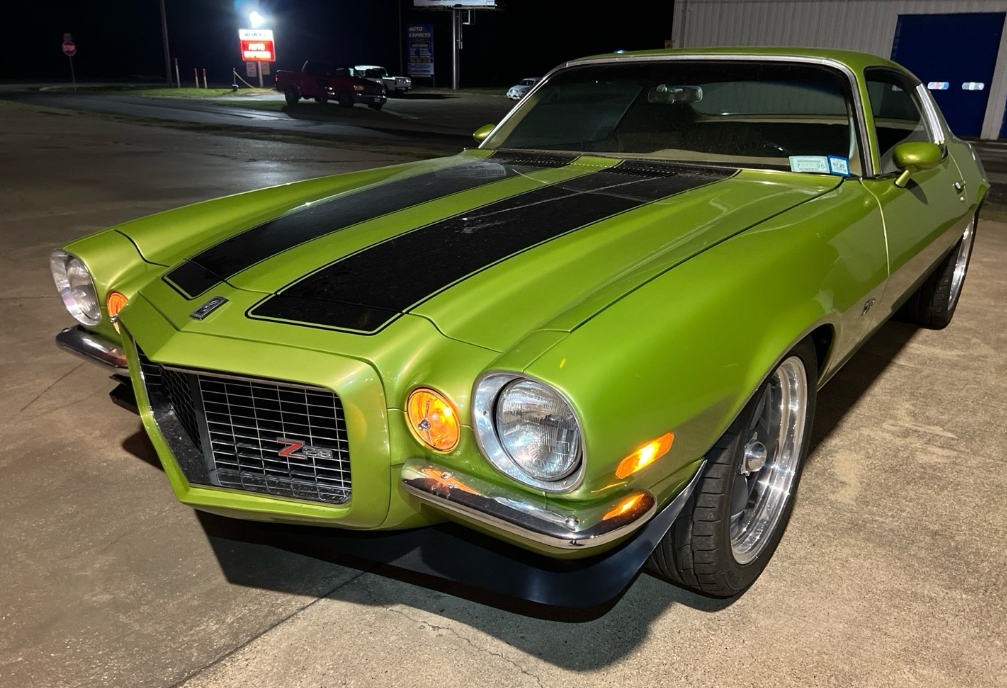 Green 1970 Chevrolet Camaro Z28 hauled by Allstar Hauling at night