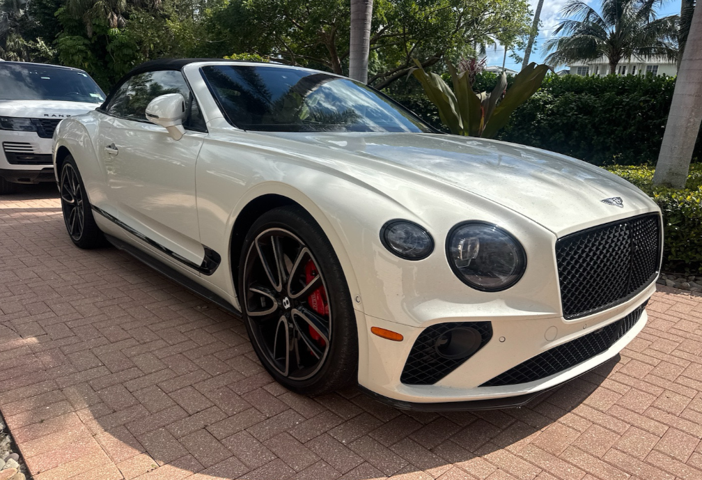 Cream Bentley Continental GT convertible with a black soft top transported by Allstar Hauling