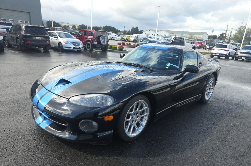 Black Dodge Viper GTS with blue racing stripes transported by Allstar Hauling